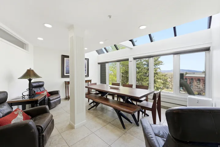 Dining room featuring light tile patterned flooring, recessed lighting, and a mountain view