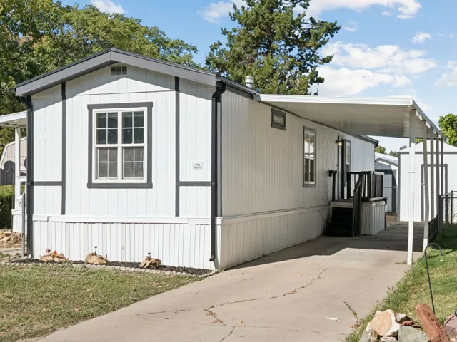 White vertical siding exterior with dark trim accents