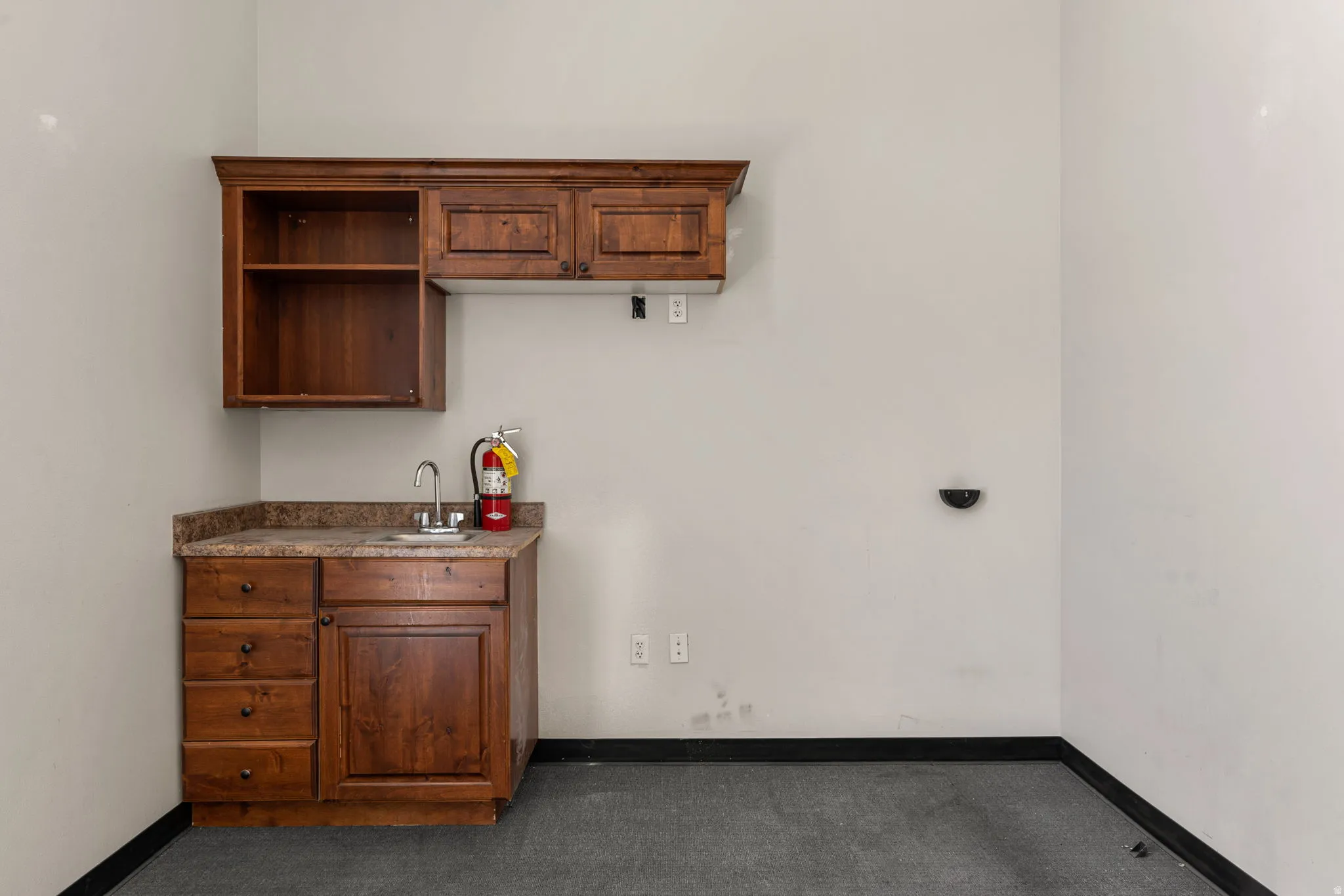 Wood-finish cabinetry with multiple drawers and upper storage