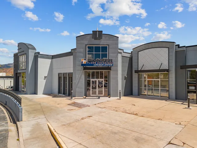 Commercial building featuring a gray stucco exterior with dark gray accents