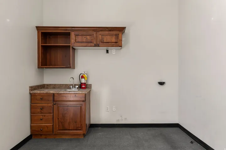 Wood-finish cabinetry with multiple drawers and upper storage