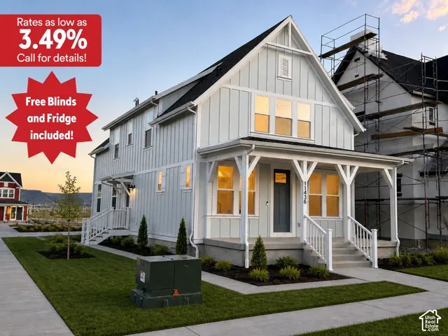 Board and batten siding, covered front porch, white railings, concrete sidewalk, and manicured lawn