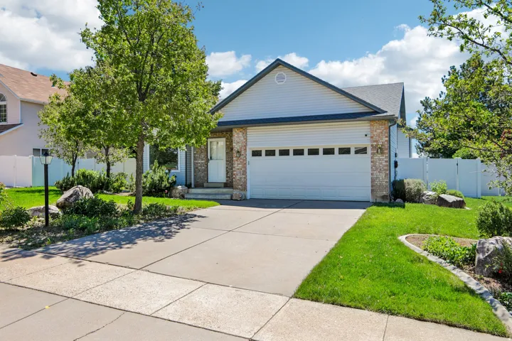 Exterior featuring light-colored siding and brick accents