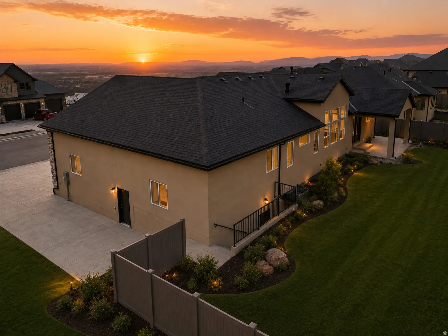 Stucco exterior with a dark shingle roof