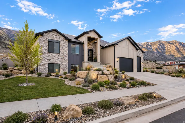 Modern exterior featuring stone and vertical panel siding
