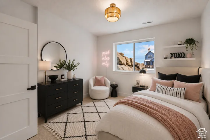 White interior door with black hardware, complementing a black dresser with a circular mirror