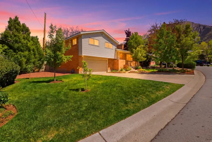 Split-level residence featuring a brick and siding exterior