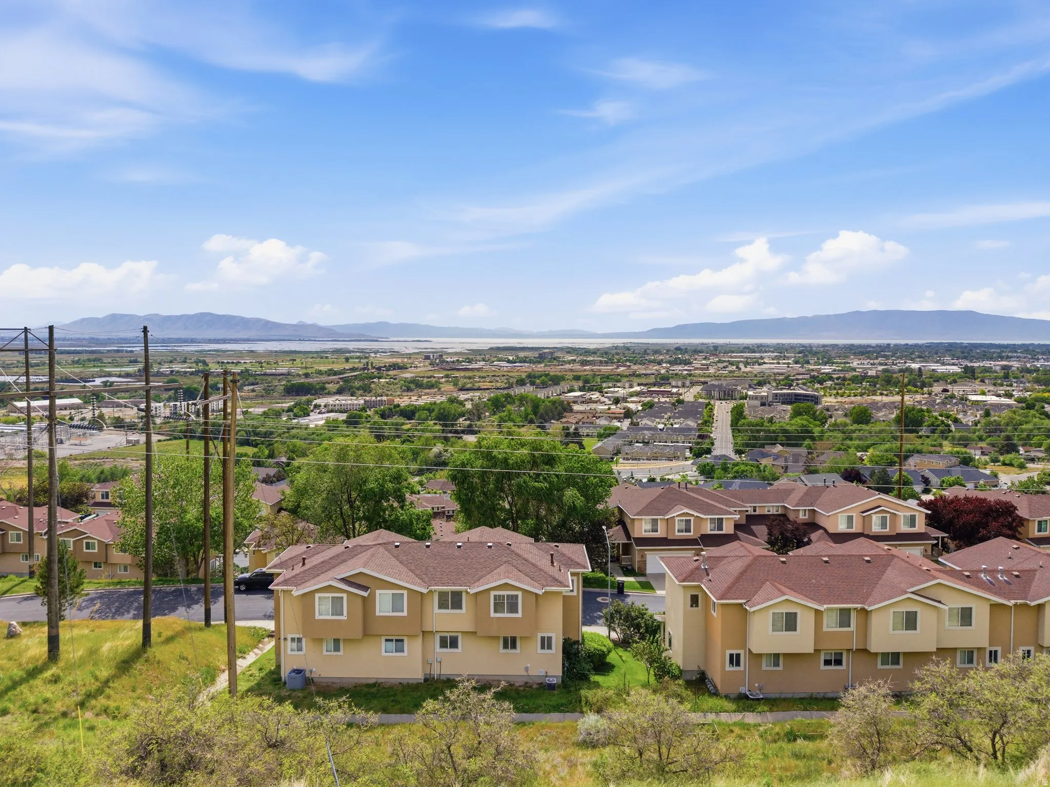 Aerial perspective showcasing residential buildings with terracotta-hued roofs and light-toned stucco exteriors