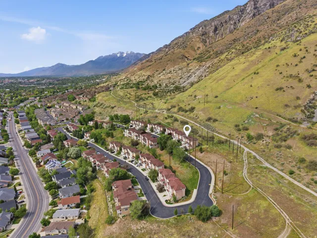 Aerial perspective showcasing a residential development nestled against a mountainside
