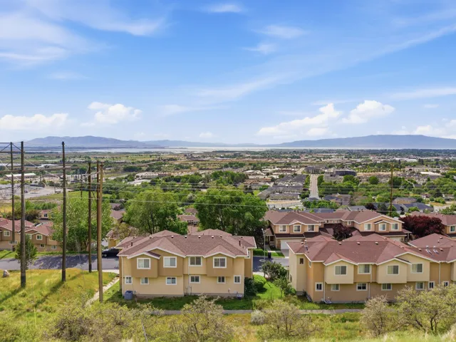 Aerial perspective showcasing residential buildings with terracotta-hued roofs and light-toned stucco exteriors