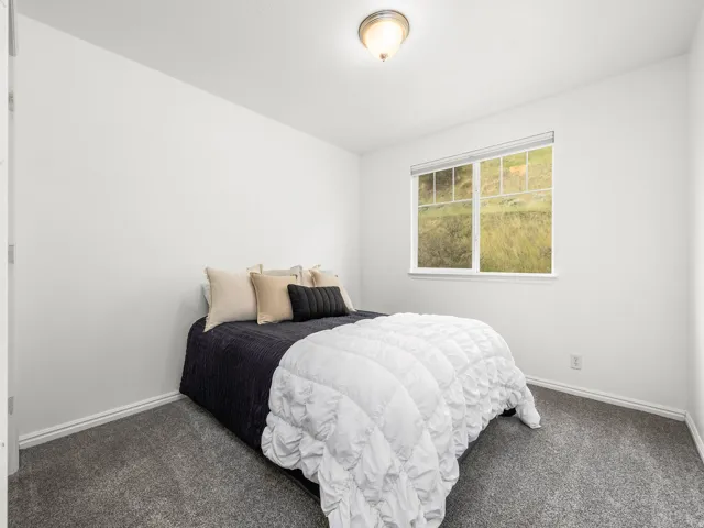White-painted walls and a ceiling-mounted light fixture illuminate this room