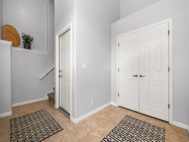 Entry foyer with tile flooring and light gray walls