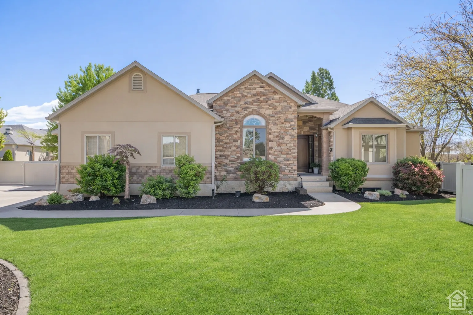 Stucco and stone facade with arched window accents