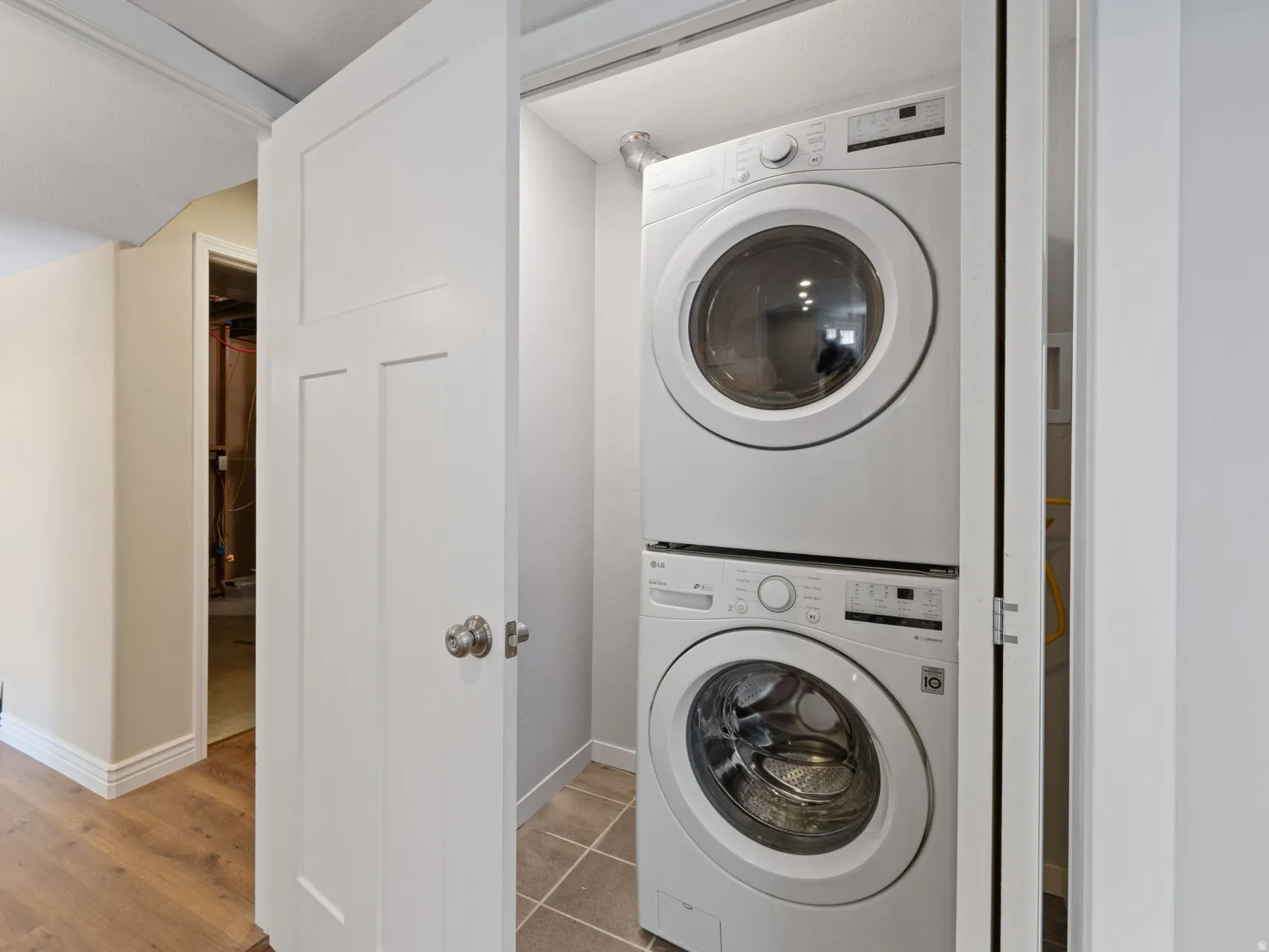 Laundry for basement apartment is in closet in unit