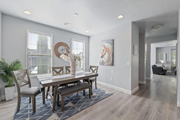 Dining area featuring wood-finish flooring and recessed lighting