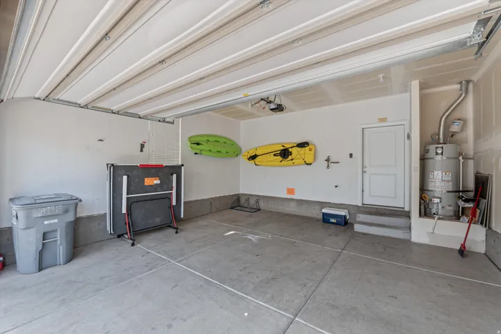 Spacious garage featuring concrete flooring and a white paneled overhead door