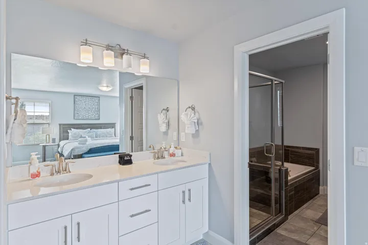 Double vanity with dual undermount sinks and white shaker-style cabinetry