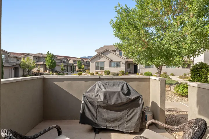 Private patio space featuring stucco walls and concrete flooring