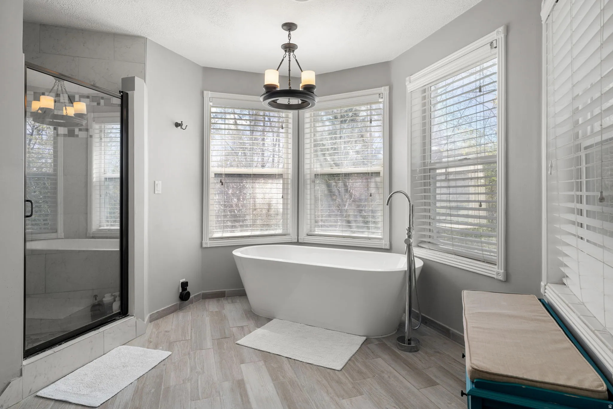 Freestanding soaking tub with floor-mounted faucet