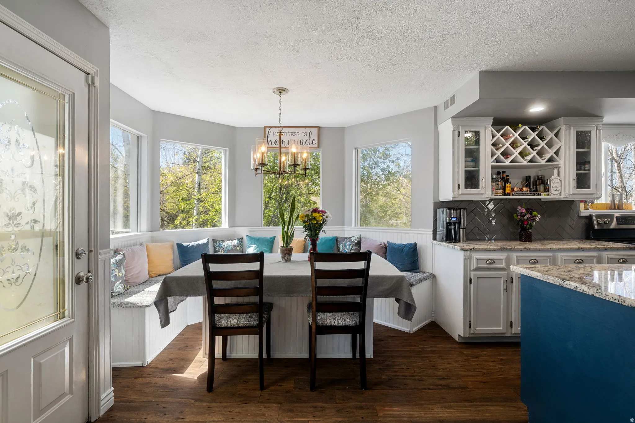 Breakfast nook with built-in bench seating and surrounding windows