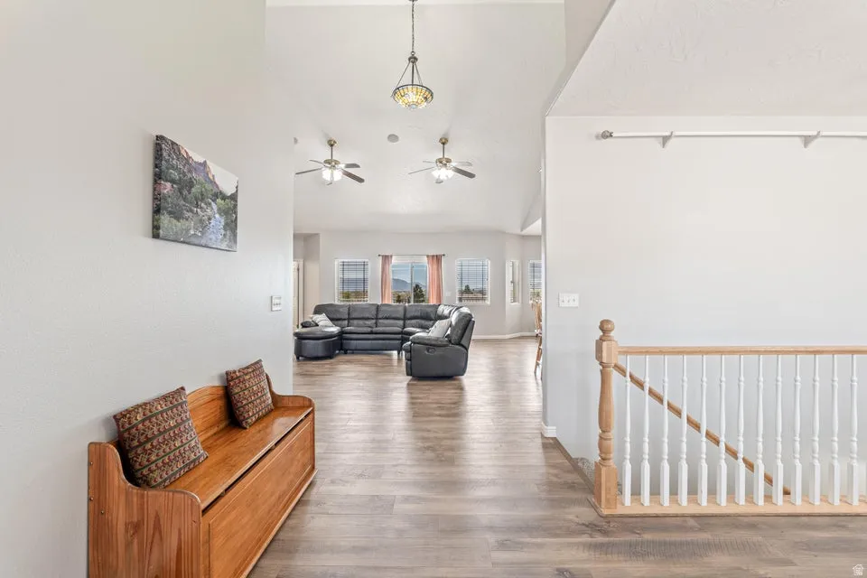 Inviting entry hall featuring wood-finish flooring, a neutral color palette, and a white balustrade staircase