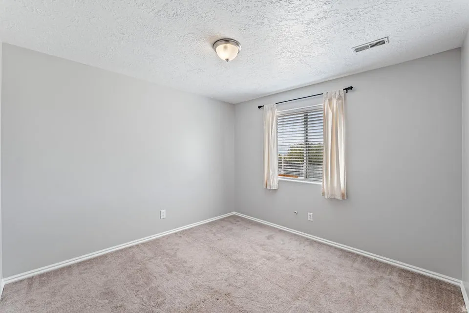 Neutral-toned carpeting paired with light gray walls and white trim