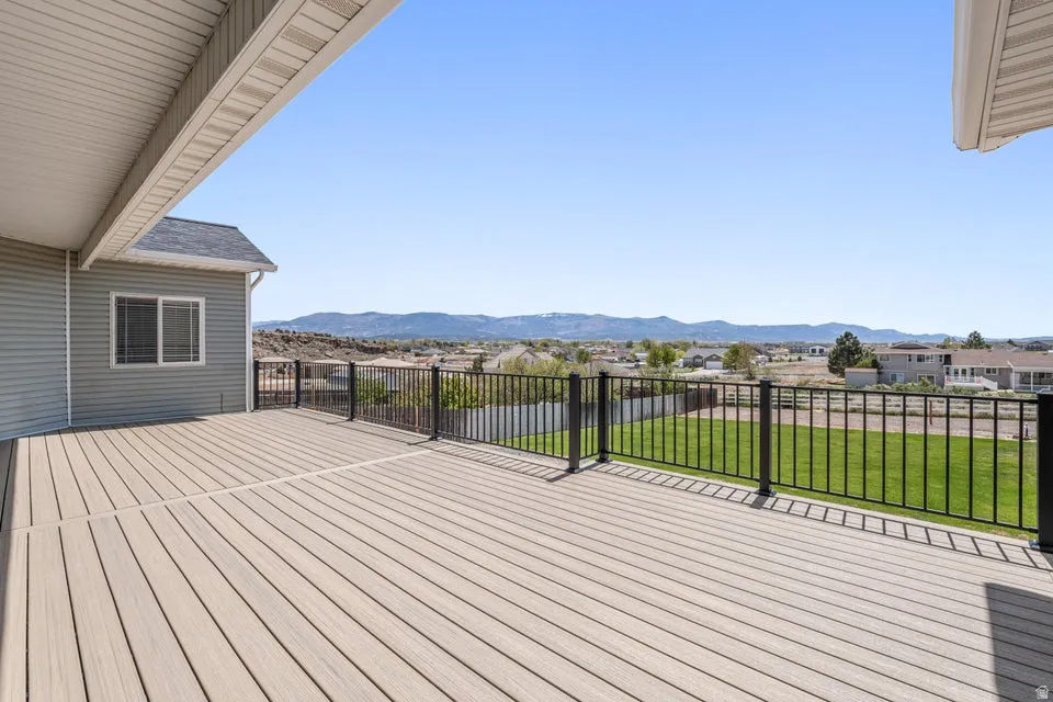 Expansive outdoor deck with composite decking and black metal railings