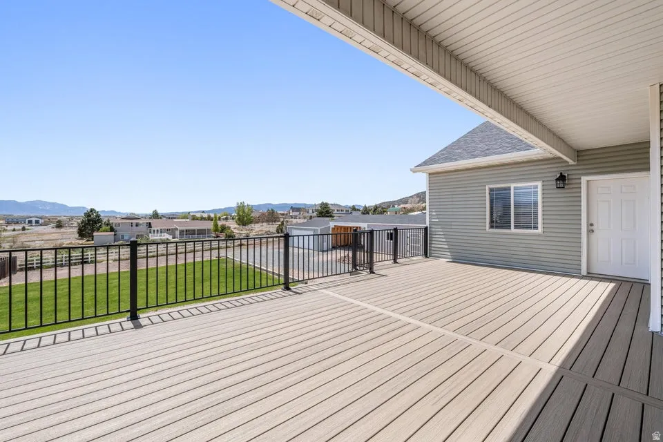 Expansive outdoor deck featuring composite decking and a black metal railing