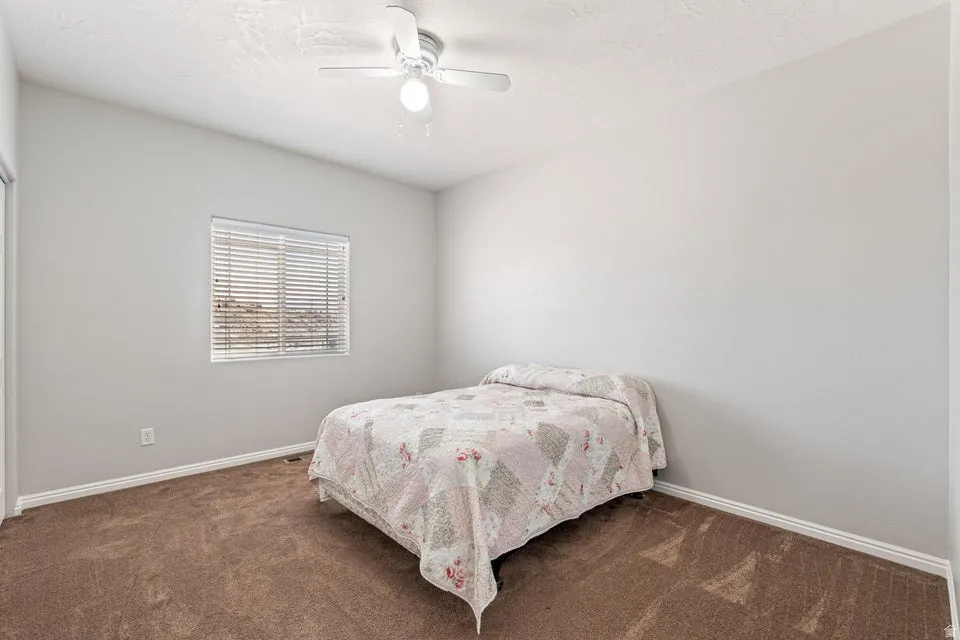 Bedroom featuring neutral wall tones and brown carpeting