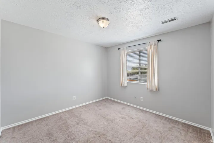 Neutral-toned carpeting paired with light gray walls and white trim