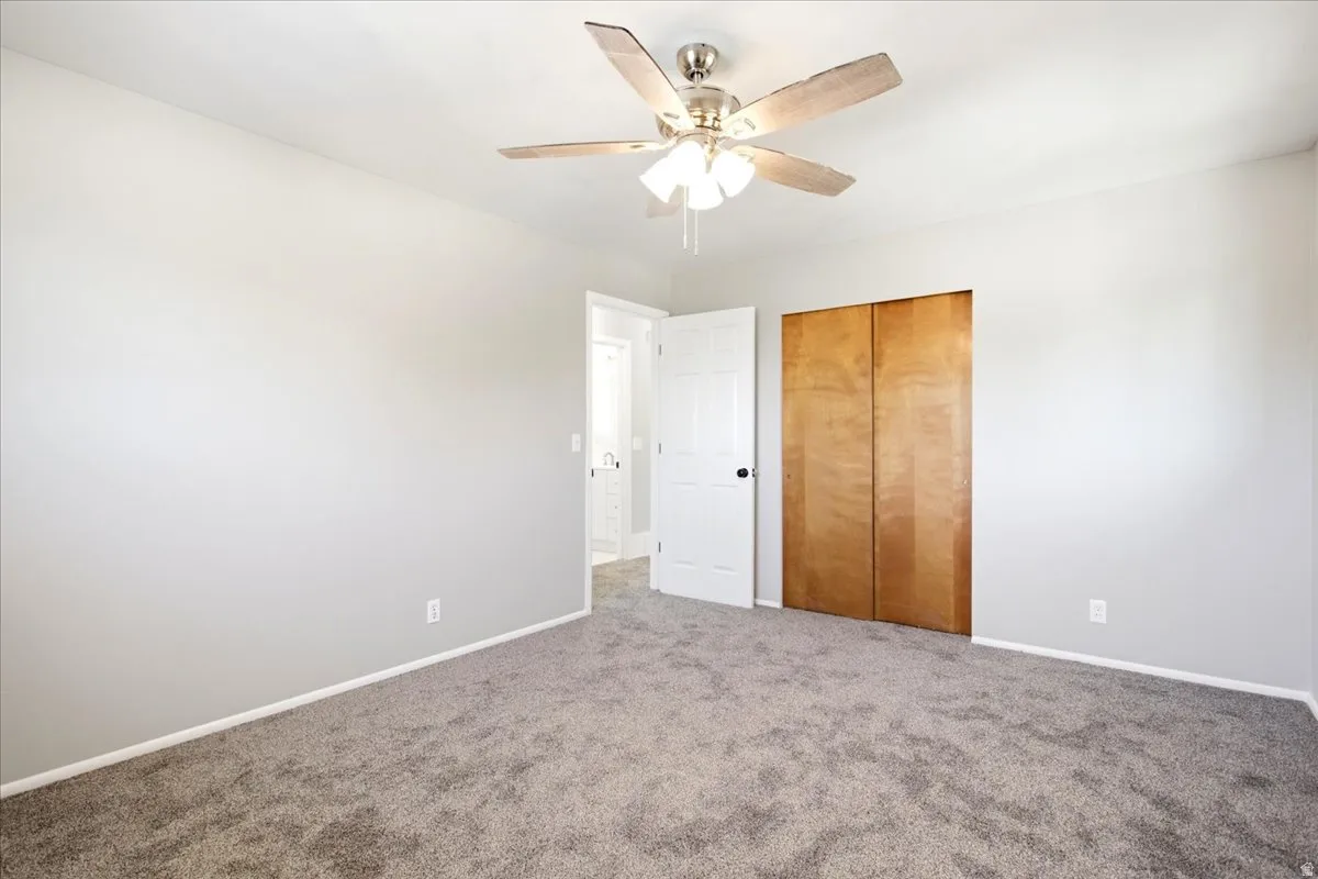 Spacious room with gray carpeting and light gray walls