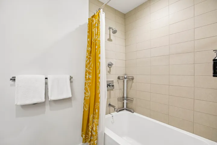White bathtub with subway-style tiled surround