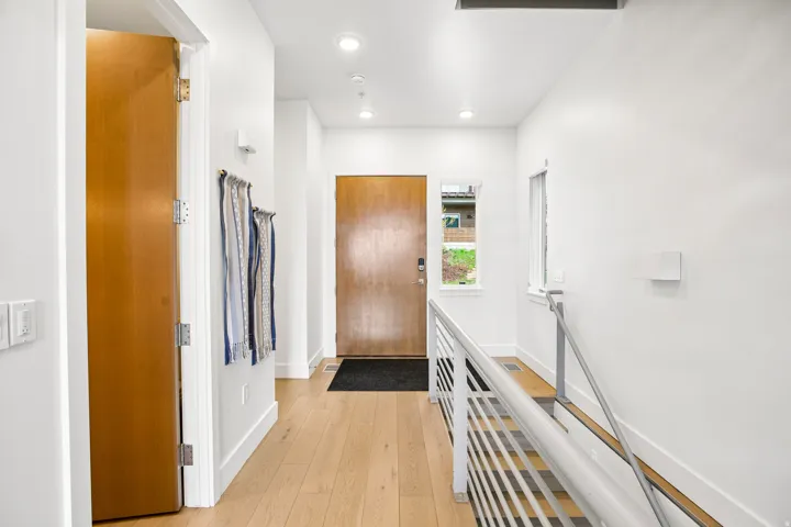 Light wood-finish flooring throughout the entryway