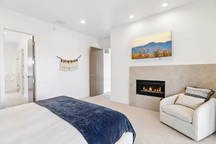 Recessed fireplace with a stone surround, integrated into a white wall
