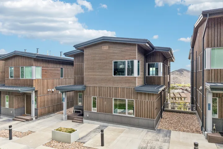 Modern architectural design featuring varied wood paneling and dark trim
