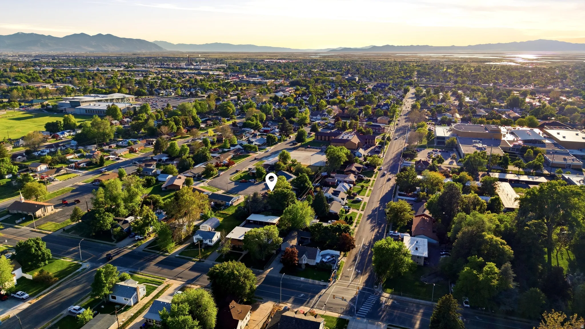 Aerial perspective showcasing a residential neighborhood with established trees and street networks