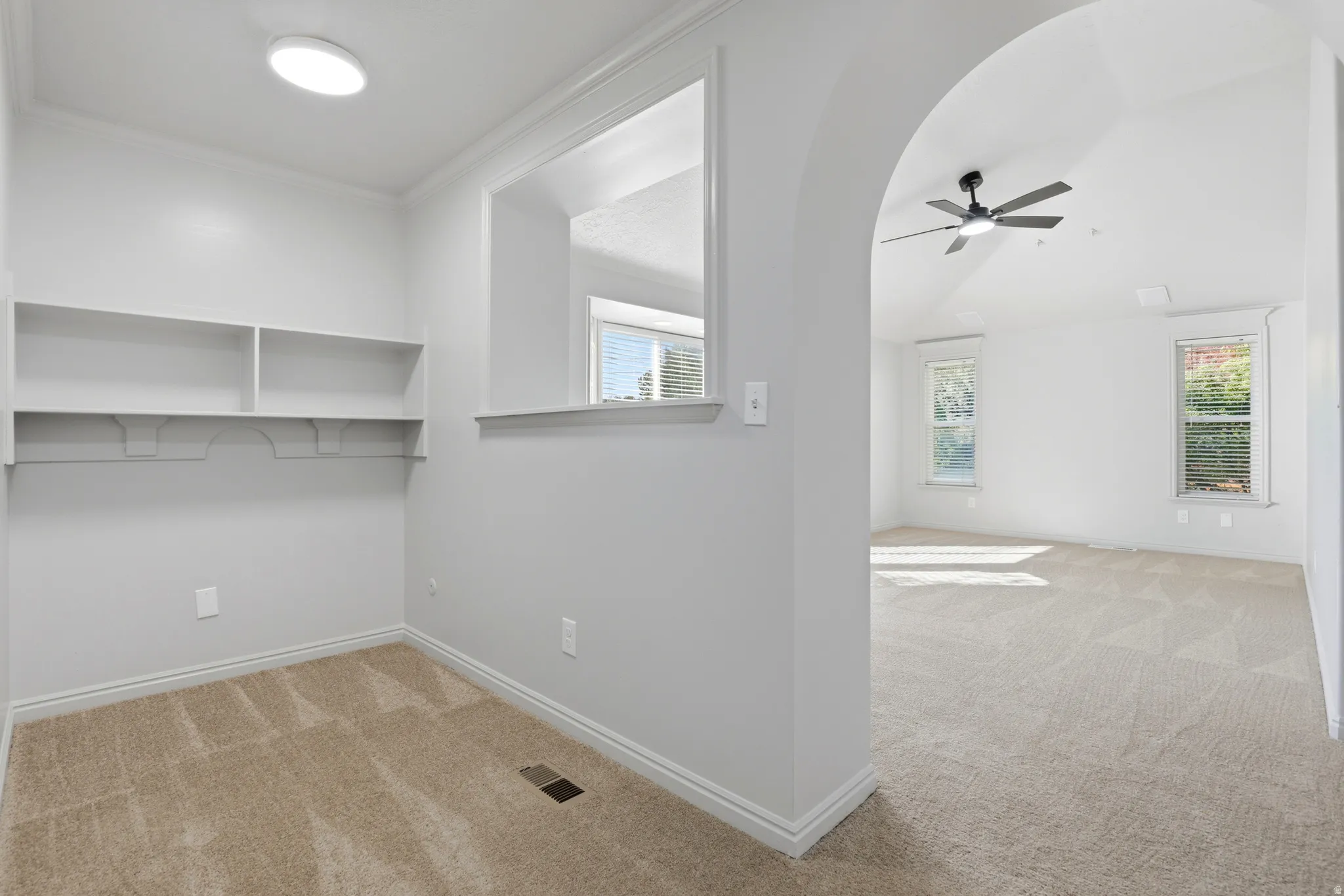 In the master by the walk in closet, Dedicated 'office space' featuring built-in shelving, plush carpeting, and a recessed light fixture