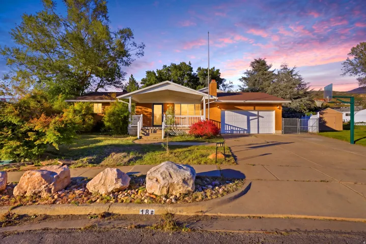 Property exterior featuring a covered front porch, attached two-car garage, and a concrete driveway