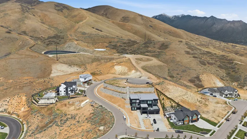 Modern homes nestled into a hillside community with winding roadways