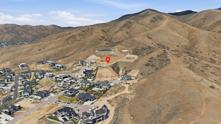 Expansive land parcel with surrounding mountainous terrain