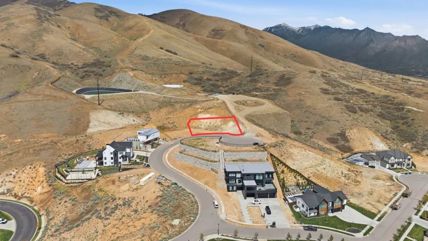 Elevated building lot highlighted, offering a gentle slope and surrounding mountainous terrain