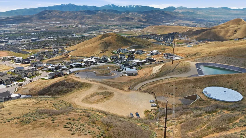 Expansive undeveloped land featuring rolling hills and distant mountain ranges