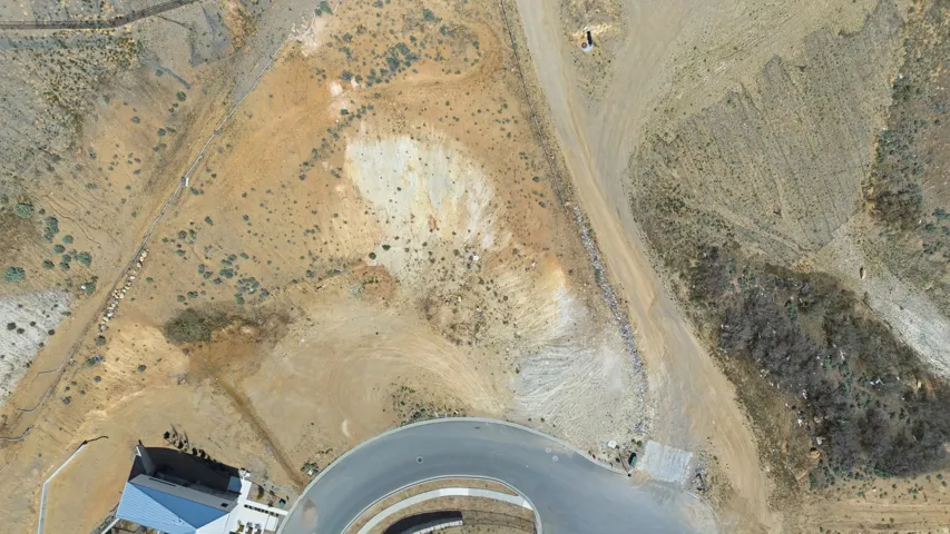 Expansive hillside property featuring natural desert landscaping and visible topographical variations