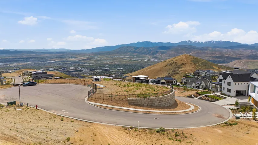 Expansive lot with a curved street frontage and a stacked stone retaining wall