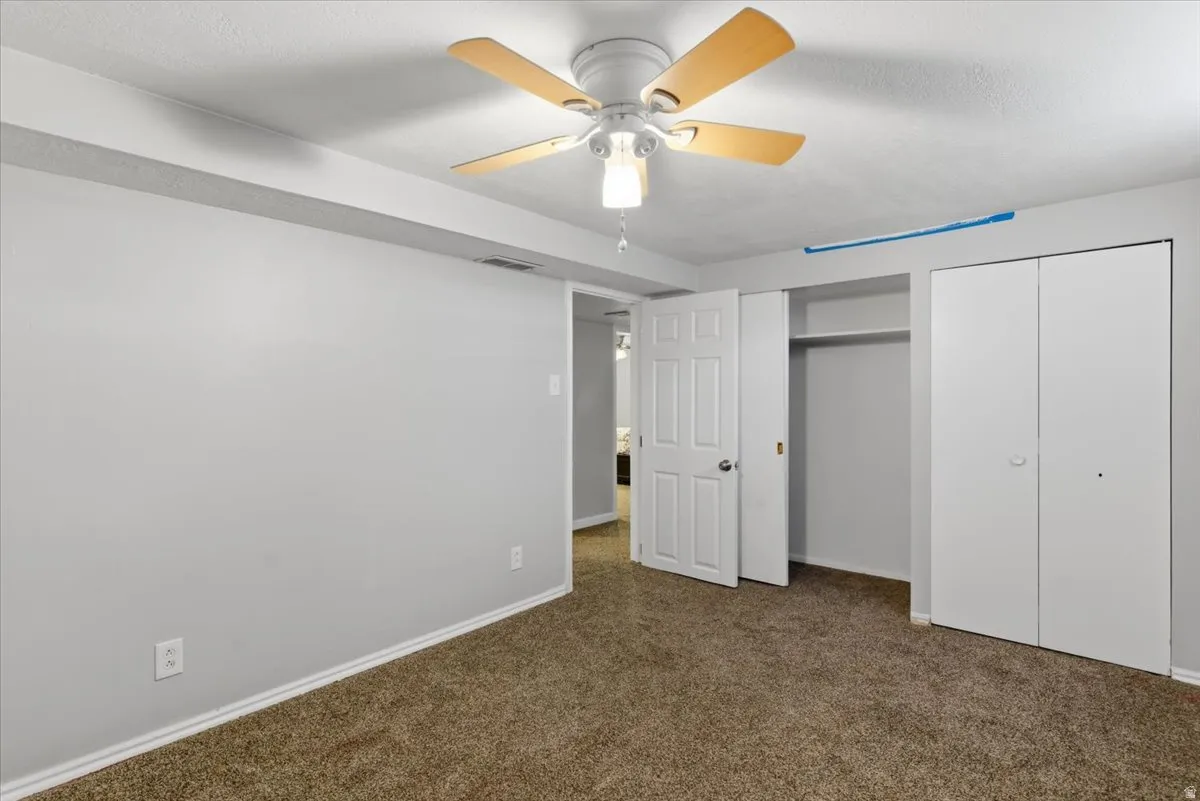 Room featuring wall-to-wall carpeting and neutral wall paint