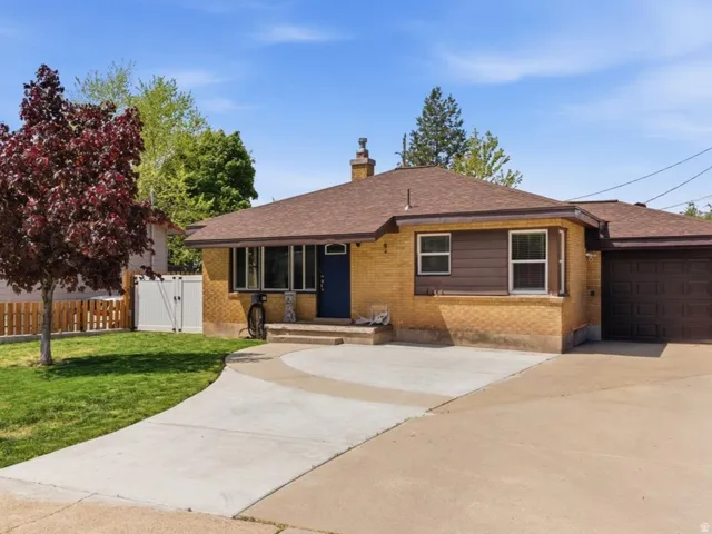 Brick exterior with a brown shingle roof