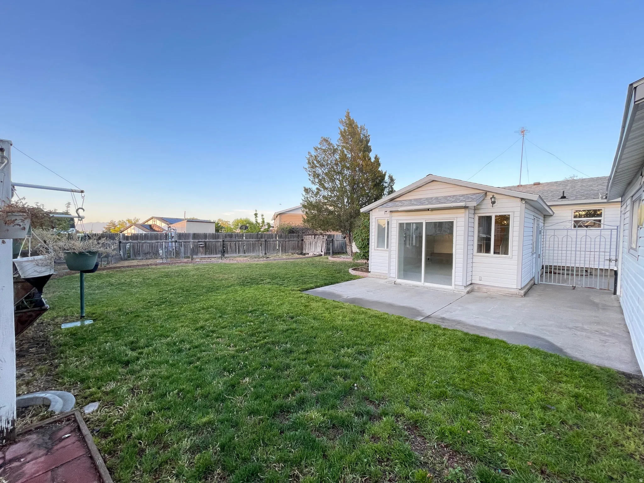 Spacious backyard and a concrete patio area