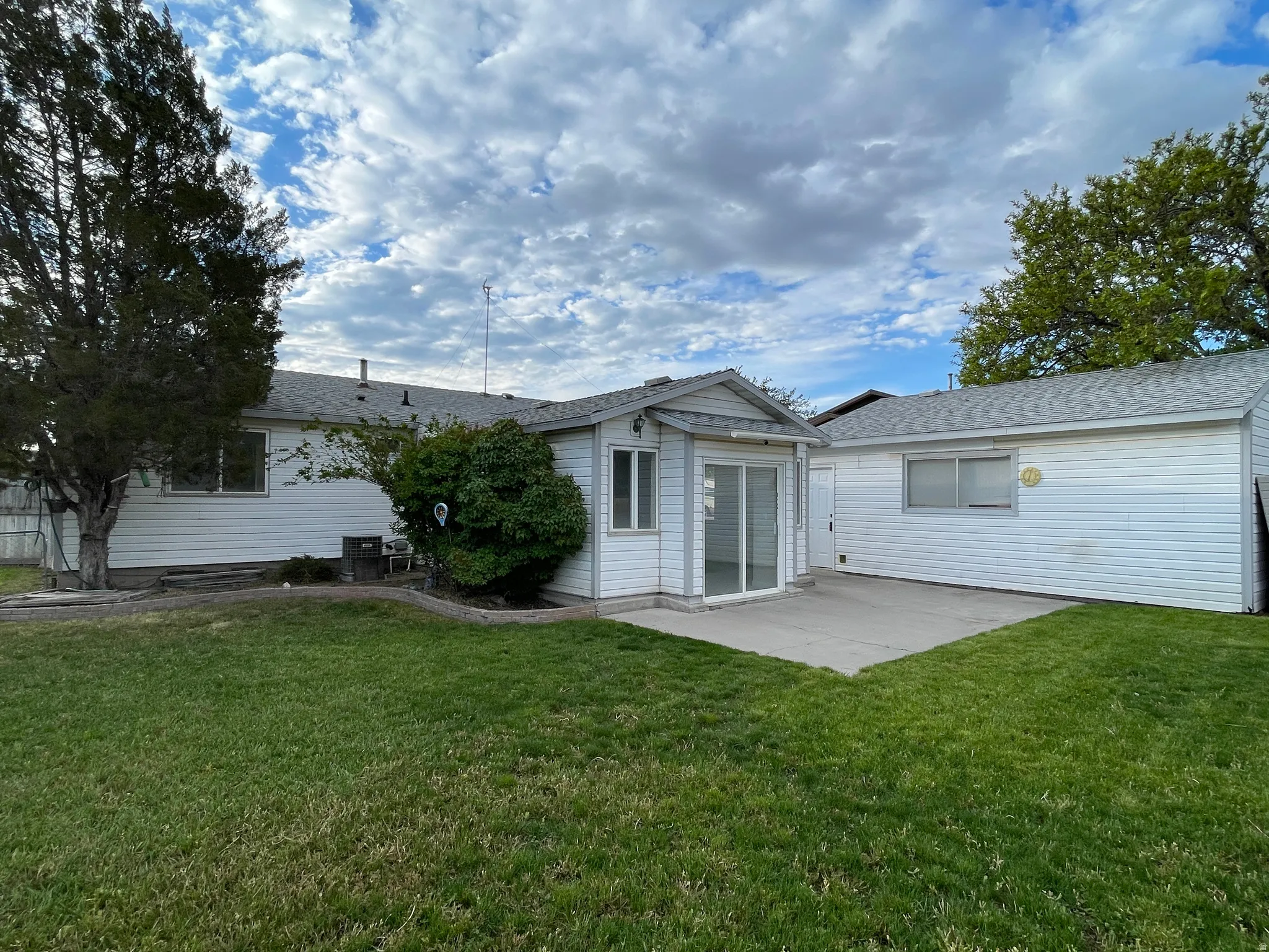 Another angle of the backyard, showing the size of the detached garage to the right.