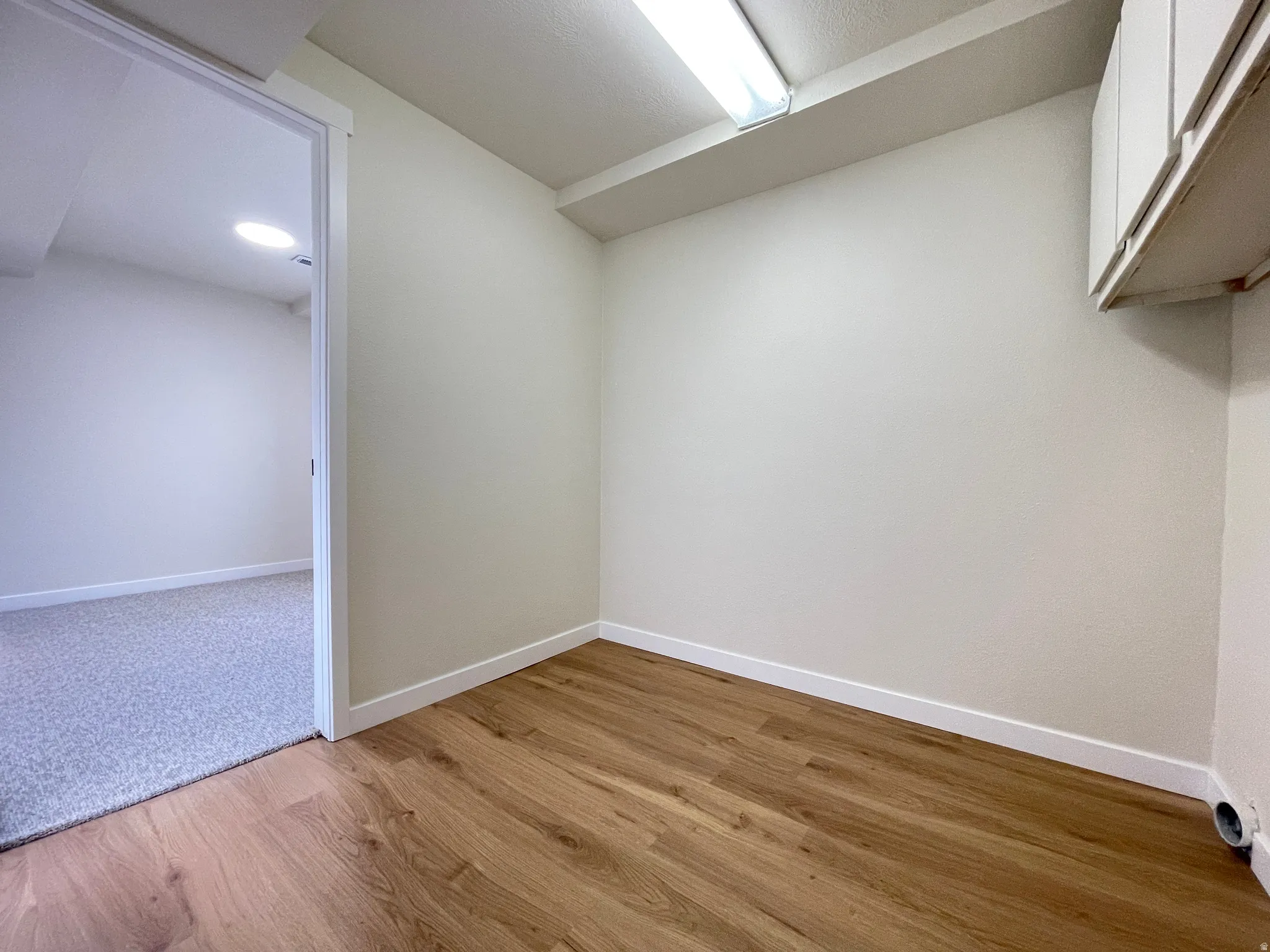Potential basement apartment Kitchen and dining area.  This is a partial view of the laundry room and bedroom #6.