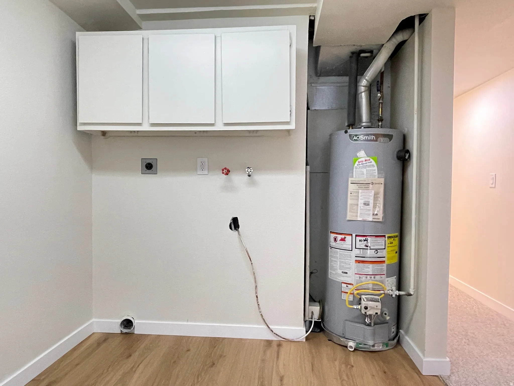 Finished laundry with water heater and furnace in view.